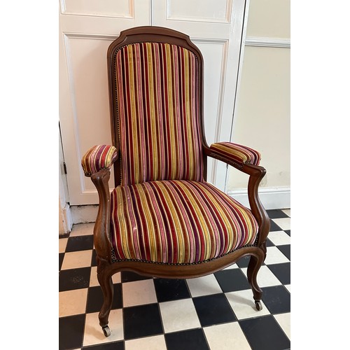 32 - A French mahogany high back armchair with upholstered seat, back and arms, front cabriole legs and c... 