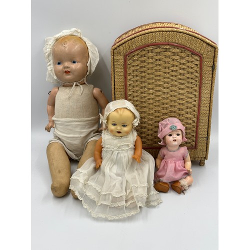 1075 - A collection of three early 20thC bisque headed dolls of various sizes together with a doll's vintag... 