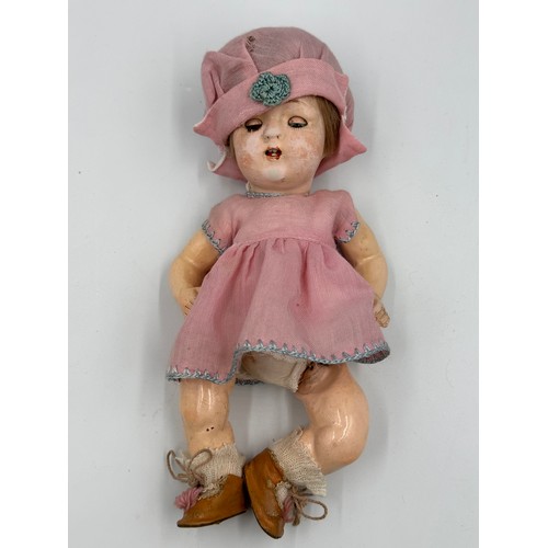 1075 - A collection of three early 20thC bisque headed dolls of various sizes together with a doll's vintag... 