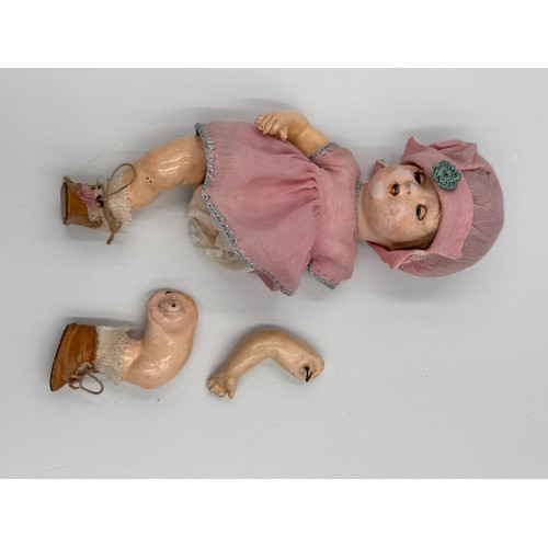 1075 - A collection of three early 20thC bisque headed dolls of various sizes together with a doll's vintag... 