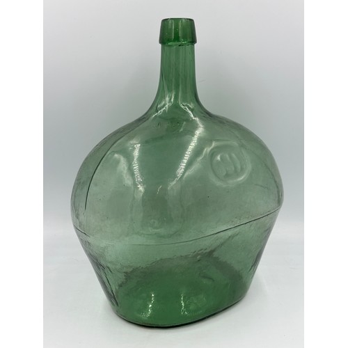 334 - A vintage green glass demijohn, probably French.
Ht approx. 37cm.