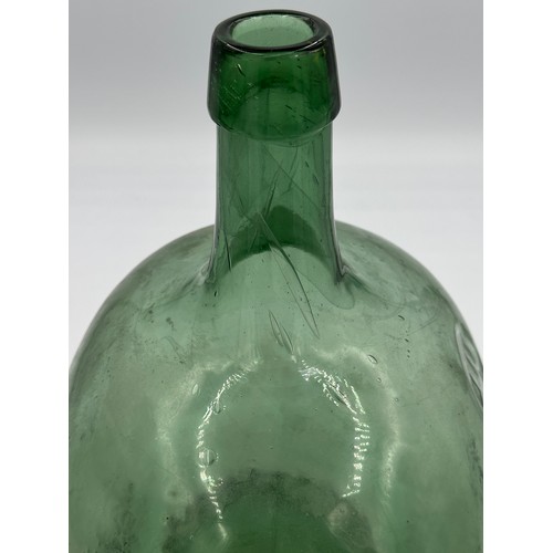 334 - A vintage green glass demijohn, probably French.
Ht approx. 37cm.