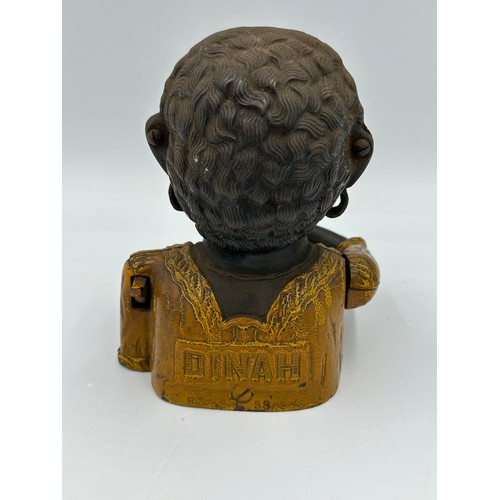 1287 - A Dinah cast iron mechanical American money box. 16cm.