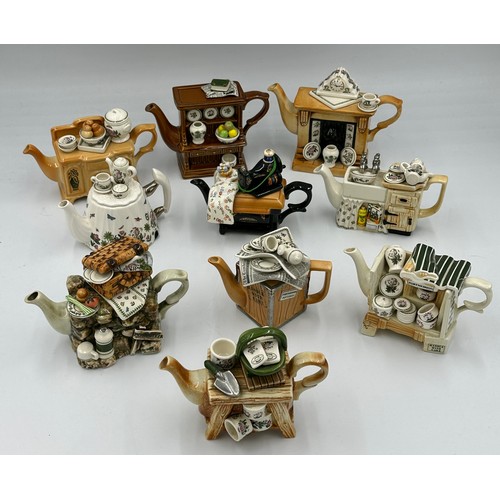 222 - Ten Portmeirion Pottery novelty teapots with boxes together with a Brexton green cased picnic set.