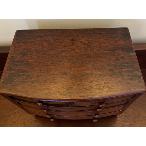 1285 - A 19thC miniature mahogany bow fronted chest of drawers with 2 short over 3 long drawers and turned ... 