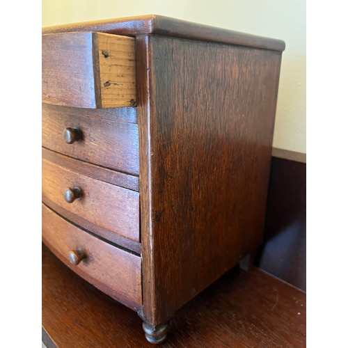 1285 - A 19thC miniature mahogany bow fronted chest of drawers with 2 short over 3 long drawers and turned ... 