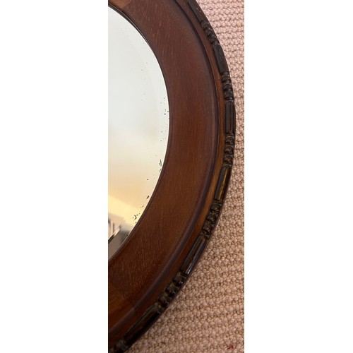 1227 - A mahogany circular bevel edged wall mirror. 47cm d.