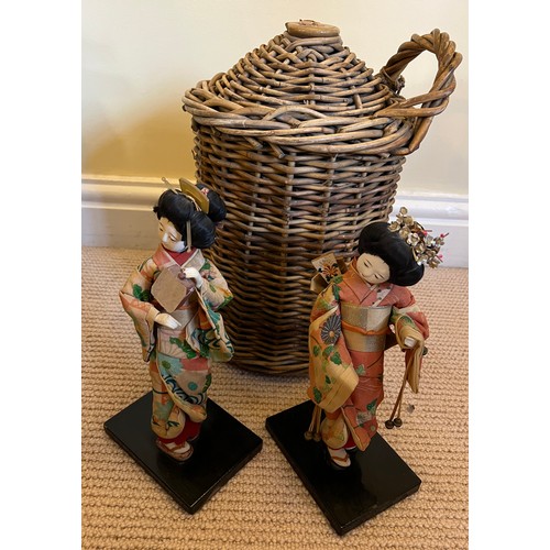 1280 - Two 1960’s Japanese costume dolls together with a harvest cider flagon in basket work holder 34cm h.