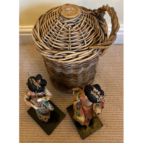 1280 - Two 1960’s Japanese costume dolls together with a harvest cider flagon in basket work holder 34cm h.