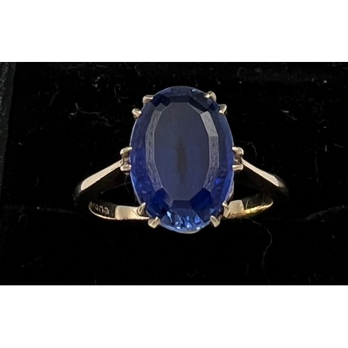 398 - A 9 carat golds ring set with blue stone. Size N, weight 4gm.