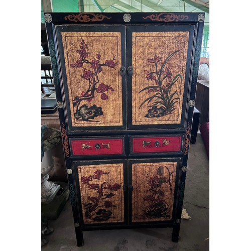 25 - A Chinese painted and lacquer cabinet with two opening doors over two drawers, over two cupboards. 1... 