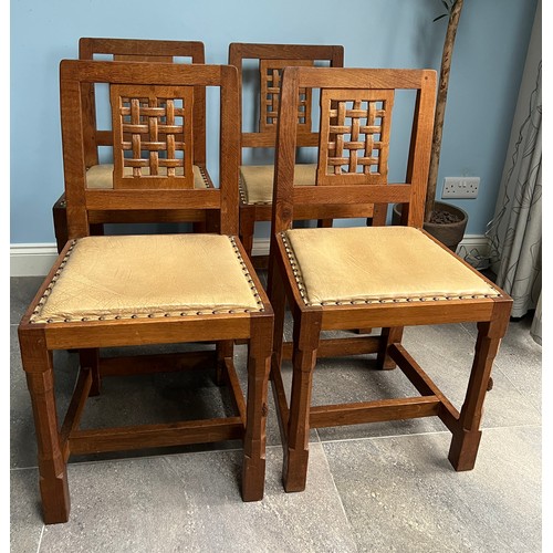 93 - A set of four Peter  Rabbitman Heap oak dining chairs with lattice backs and leather seats with carv... 