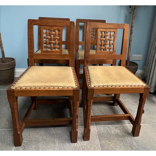 93 - A set of four Peter  Rabbitman Heap oak dining chairs with lattice backs and leather seats with carv... 