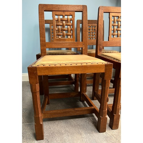 93 - A set of four Peter  Rabbitman Heap oak dining chairs with lattice backs and leather seats with carv... 