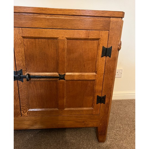 96 - A Rabbitman Peter Heap of Wetwang oak sideboard with adzed top having cupboard to each side and draw... 