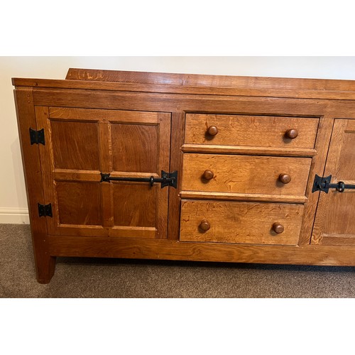 96 - A Rabbitman Peter Heap of Wetwang oak sideboard with adzed top having cupboard to each side and draw... 