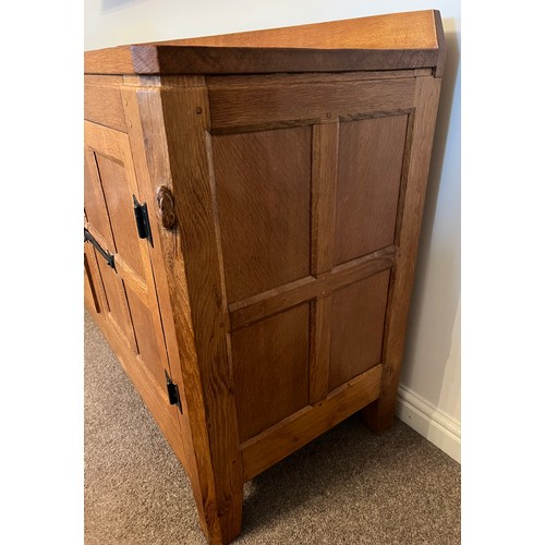 96 - A Rabbitman Peter Heap of Wetwang oak sideboard with adzed top having cupboard to each side and draw... 