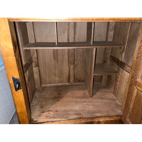 97 - An oak Rabbitman Peter Heap of Wetwang bedside cupboard each with single panelled door and sides. 61... 