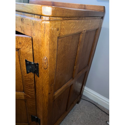 97 - An oak Rabbitman Peter Heap of Wetwang bedside cupboard each with single panelled door and sides. 61... 