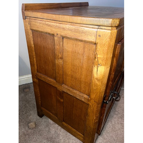 97 - An oak Rabbitman Peter Heap of Wetwang bedside cupboard each with single panelled door and sides. 61... 