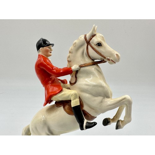 208 - Beswick model of Huntsman on rearing horse, no. 868, together with three Beswick hounds.