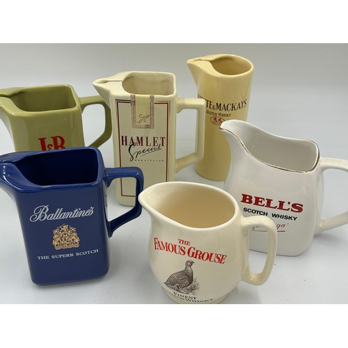 275 - Breweriana x 11 ceramic jugs to include Beefeater, Johnny Walker, Long John, The Famous Grouse, Whit... 