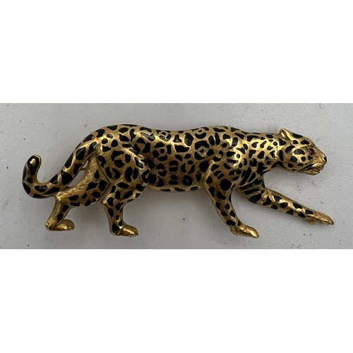 367 - A 18 carat gold leopard brooch with ruby eyes and black enamelled decoration Weight 9.1gm. 5cm l.