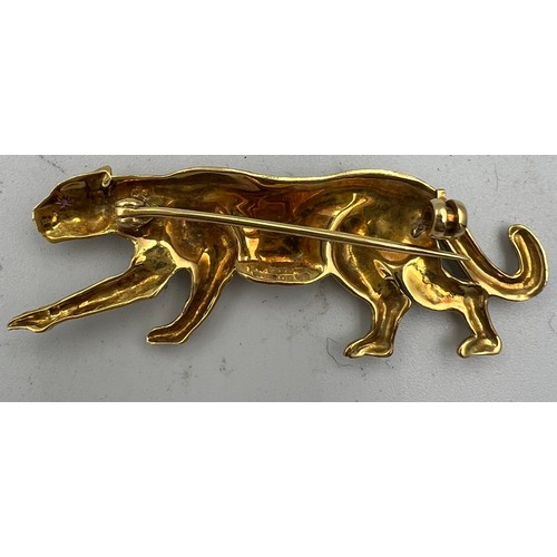 367 - A 18 carat gold leopard brooch with ruby eyes and black enamelled decoration Weight 9.1gm. 5cm l.