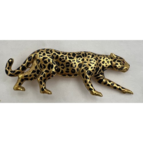 367 - A 18 carat gold leopard brooch with ruby eyes and black enamelled decoration Weight 9.1gm. 5cm l.