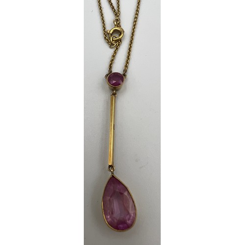 369 - A 15 carat gold and pink stone pendant. Weight 4.1gm. 25cm length.