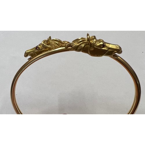 377 - A 18 carat gold horse head bangle with ruby eyes. Weight 22.7gm.