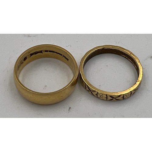 403 - Two 18 carat gold wedding bands, one with decoration. Size N. Total weight 8.2gm.