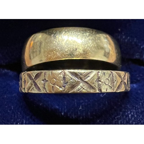 403 - Two 18 carat gold wedding bands, one with decoration. Size N. Total weight 8.2gm.