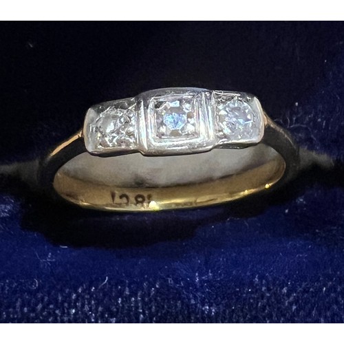 405 - An 18 carat gold ring set with 3 diamonds. Size M. Weight 2.5gm.