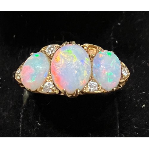 408 - A 19thC 18 carat gold ring set with opals and diamonds. Size L. Weight 4.5gm.