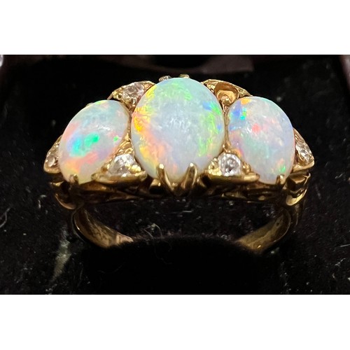 408 - A 19thC 18 carat gold ring set with opals and diamonds. Size L. Weight 4.5gm.