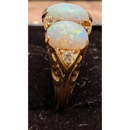 408 - A 19thC 18 carat gold ring set with opals and diamonds. Size L. Weight 4.5gm.