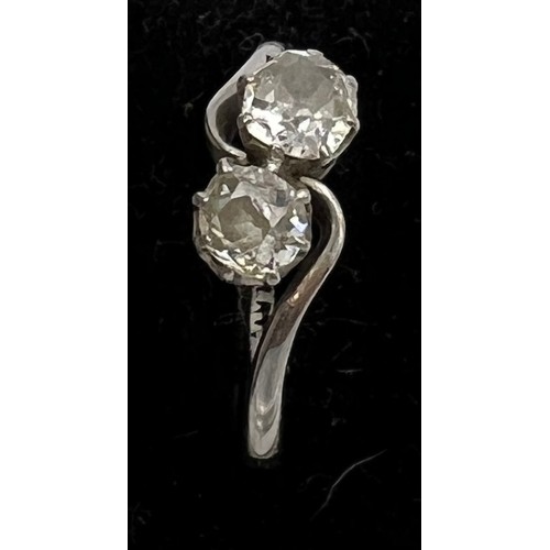 412 - A platinum ring set with two diamonds in a crossover setting. Size P. Weight 3.6gm.