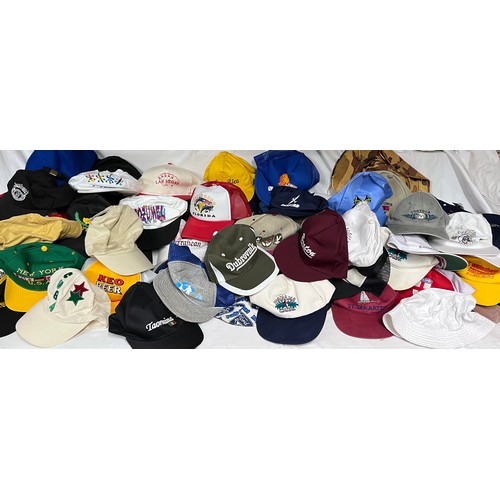 944 - A large quantity of mainly baseball caps collected over many years from multiple holiday destination... 