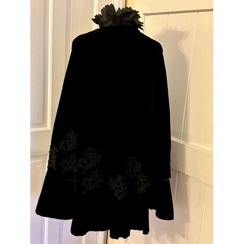 938 - A Victorian black velvet cape with stand up taffeta collar and applied decoration. Back of neck to h... 