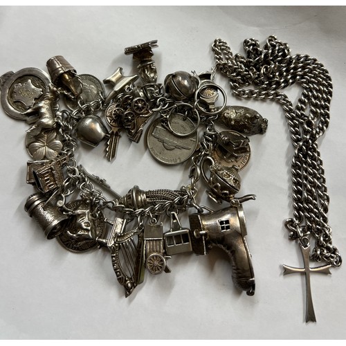 363 - A silver charm bracelet and multiple charms together with .925 crucifix on chain. Total weight 142.6... 