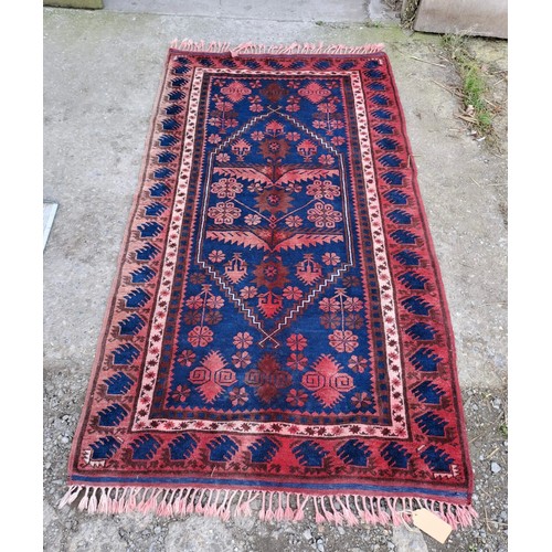 1239 - A good quality rug in shades of blue and red. 290cm x 80cm.