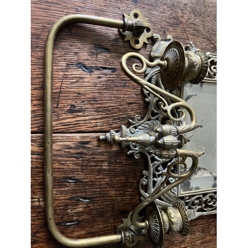 1191 - An ornate Victorian brass mirror with candle holders to base bearing registration lozenge to back, t... 