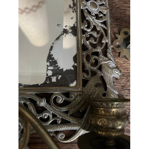 1191 - An ornate Victorian brass mirror with candle holders to base bearing registration lozenge to back, t... 