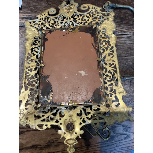 1191 - An ornate Victorian brass mirror with candle holders to base bearing registration lozenge to back, t... 