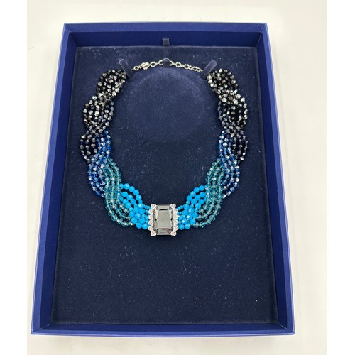 359 - A Swarovski crystal collar necklace in four shades of blue crystals with clear single dark crystal t... 