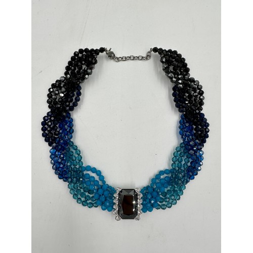 359 - A Swarovski crystal collar necklace in four shades of blue crystals with clear single dark crystal t... 