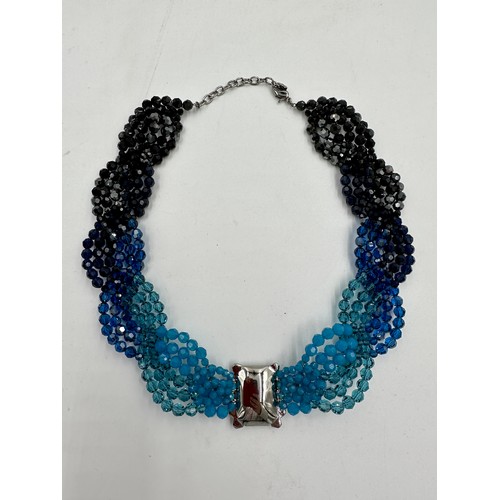 359 - A Swarovski crystal collar necklace in four shades of blue crystals with clear single dark crystal t... 