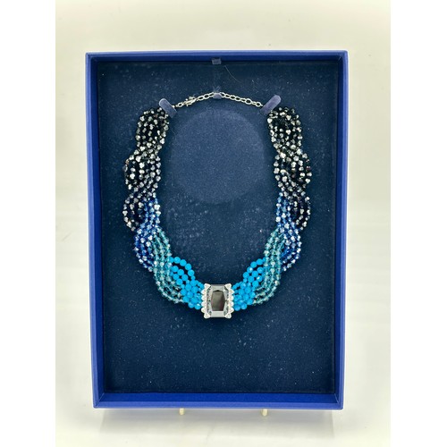 359 - A Swarovski crystal collar necklace in four shades of blue crystals with clear single dark crystal t... 