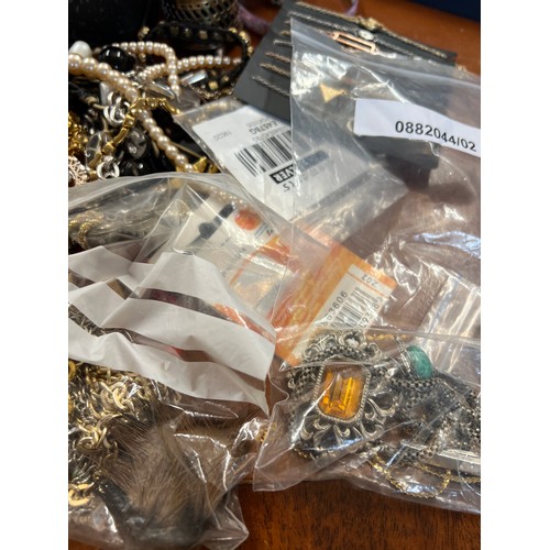 344 - A very large quantity of costume jewellery to include vintage watch movements, cufflinks, 2 x Nomina... 